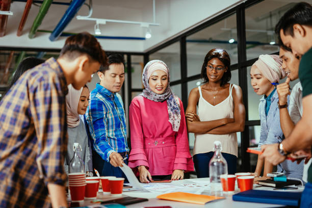 Multi ethnic diverse business team in office, teamwork on new post-covid project