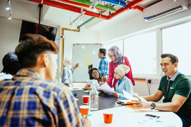 istock Multi ethnic business team back in the office after covid-19 vaccination 1299562540