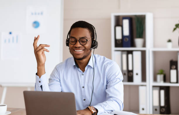 istock Positive african young man having business conference in office 1299563255