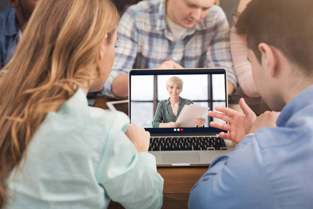 istock Business Colleagues At Laptop Computer Making Video Call In Office 1299563314