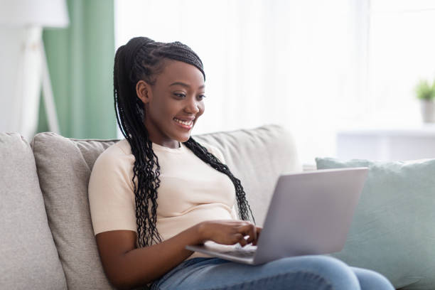 istock Happy black woman freelancer working from home, using modern laptop 1299563964