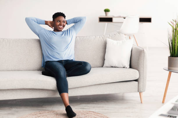 istock Black woman having rest at home on the couch 1299564048