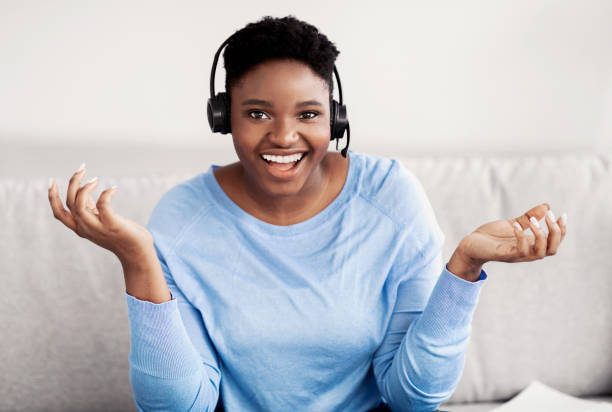 istock Black woman sitting, talking to camera wearing headset 1299564078