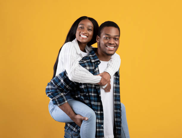 istock Happy man carrying girlfriend on his back, fun together and enjoying date 1299564919