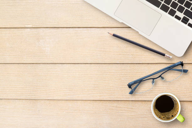 istock Office desk table with laptop computer, black pencil,glasses and cup of coffee. 1299565318
