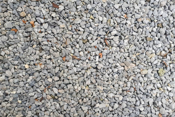 istock Natural stone pebble material texture background. stone background, dark gravel pebbles stone 1299565379