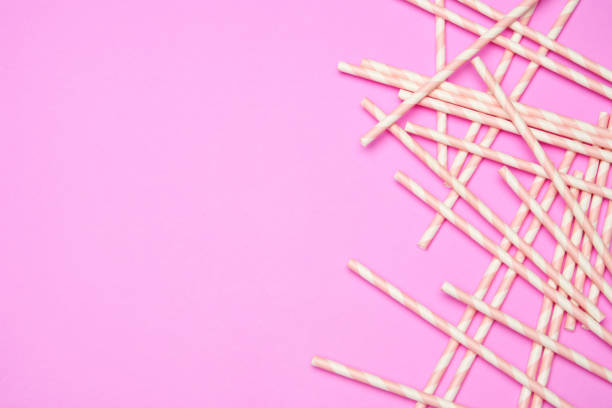 istock Flat lay with striped drink straws on pink background 1299566295