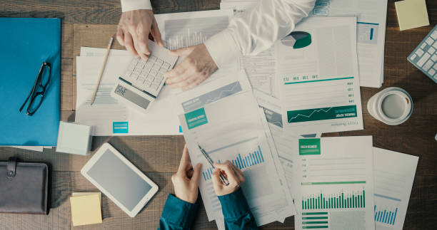 istock Business people checking financial charts together 1299568203