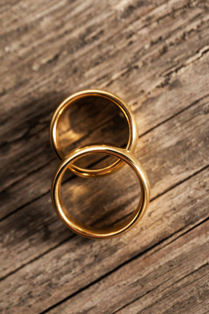 istock Golden wedding rings on wood 1299569586