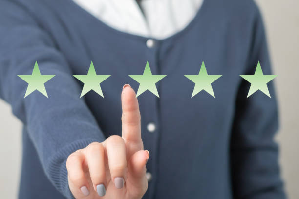 istock Women's hands and star rating icon 1299571599