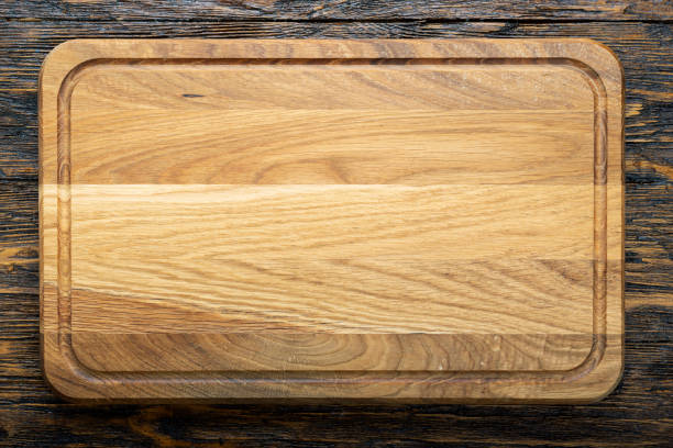 istock Cutting wooden board of rectangular shape on a wooden background.  Space for text. 1299571733