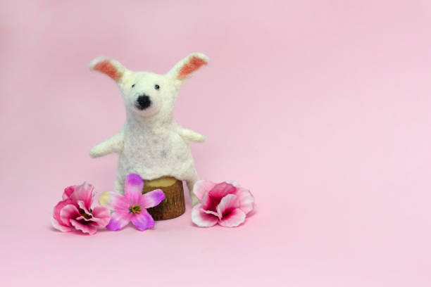 istock Happy Easter. DIY bunny, eggs and flowers on pink background. Easter card is decorated with a homemade design. 1299571861