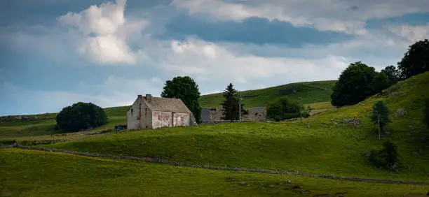 lonely run down  farm house on the aubrac  plateau Lozere france. with cloudy skys