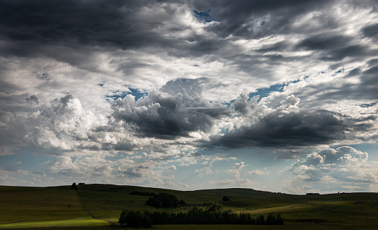 Big sky over a high plateau ,  France ,with stream of sunlight on the landscape ,