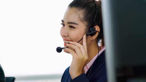istock Business people wearing headset working in office 1299572674