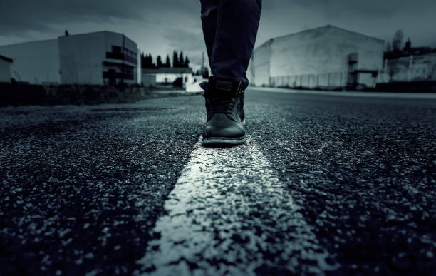 istock Person walking on road line 1299572713