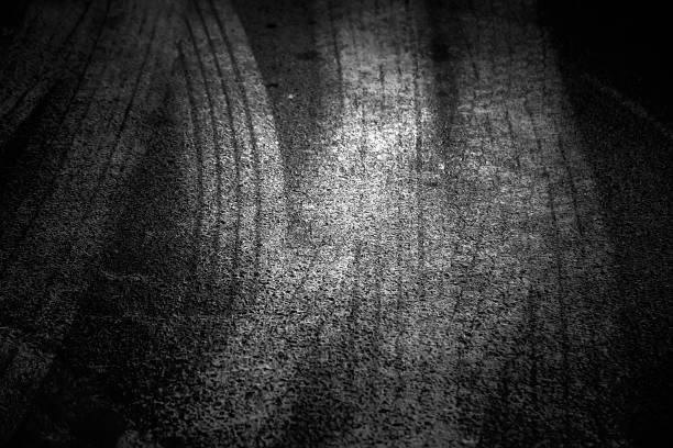 istock Wheel tracks on street 1299572728