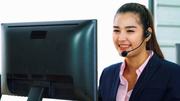istock Business people wearing headset working in office 1299573200