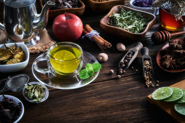 istock High angle view of a cup of hot tea lemon infusion on a rustic table with honey jar 1299573922