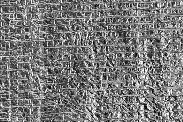 istock gray crumpled aluminum foil with square structure 1299573975