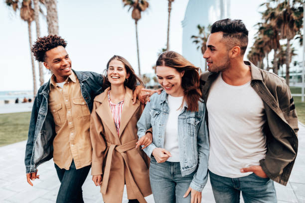 istock friends embracing and walking in Barceloneta 1299574213
