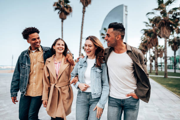 istock friends embracing and walking in Barceloneta 1299574986