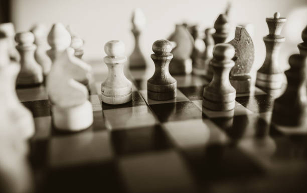 istock Wooden chess pieces on the chessboard. 1299575233