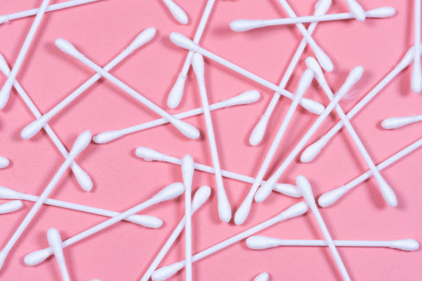 istock Cotton buds, ear sticks on pink backround. Flat lay, top view. 1299575908