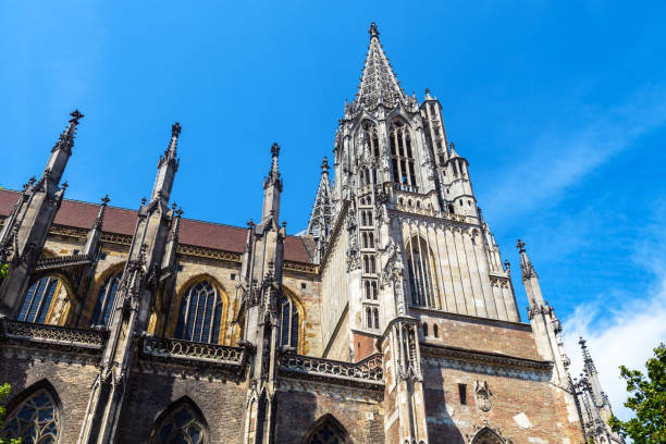Ulm Minster or Cathedral of Ulm city, Germany Ulm Minster or Cathedral of Ulm city, ornate Gothic church exterior in summer, Germany. It is famous landmark of old Ulm. Scenery of medieval European architecture on blue sky background. ulm minster stock pictures, royalty-free photos & images