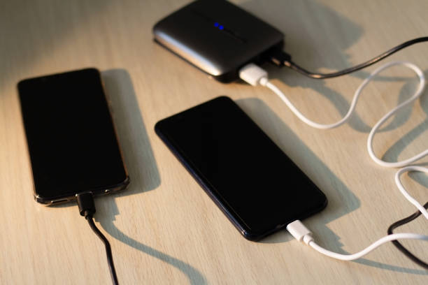 istock Charging your smartphone from a portable charger, close-up. 1299577207