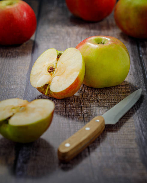 istock still life with apple and knife on wooden table 1299577387