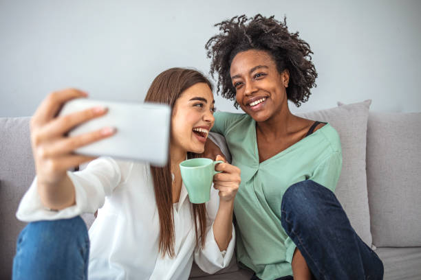 istock Excited multicultural friends taking selfie and laughing. 1299578249