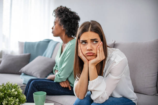 istock Unhappy friends not talking after argument on the couch 1299578317