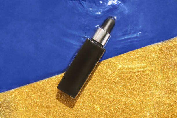 istock Water circle with sparkles background. Black serum bottle. Copyspace mockup 1299578704