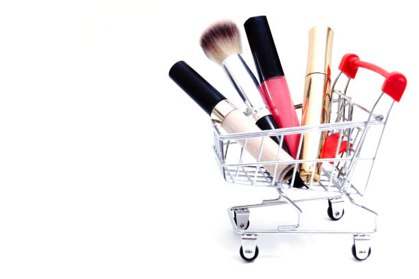 istock Shopping cart with cosmetics on white background 1299578743