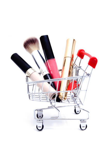 istock Shopping cart with cosmetics on white background 1299578750