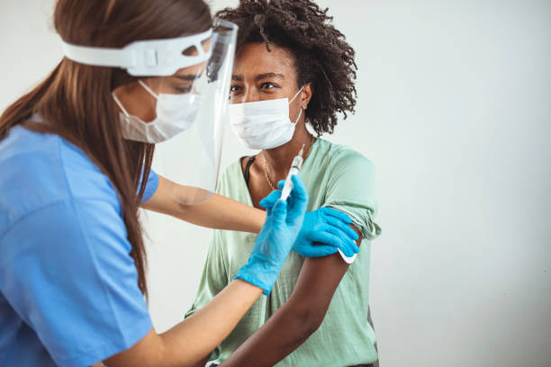 istock Nurse holding syringe and using cotton before make Covid-19 or coronavirus vaccine. 1299580448