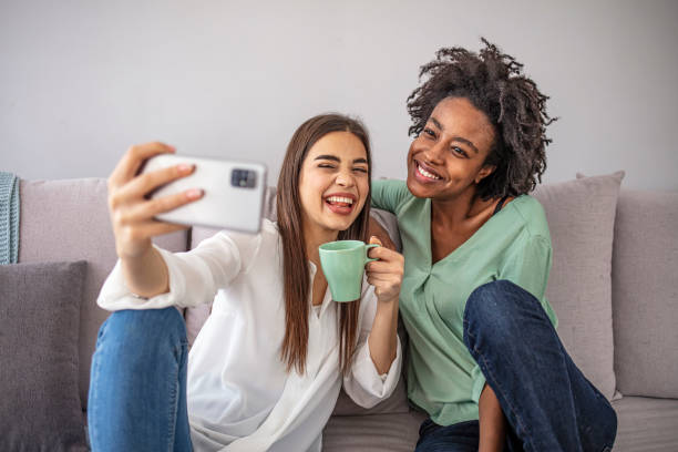istock Two adult woman making selfies. 1299580549
