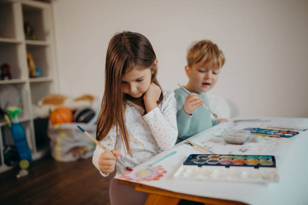 istock Brother and Sister painting 1299581678