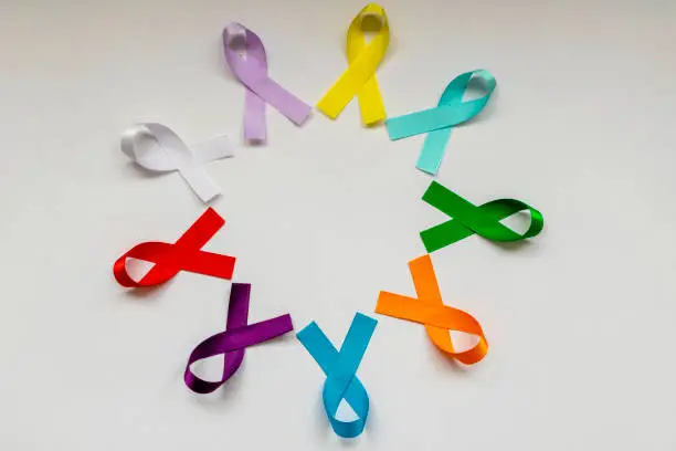 circle with colored ribbons of disease prevention campaigns