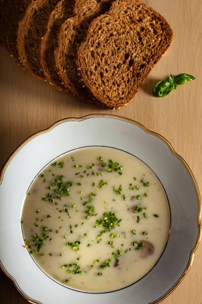 istock Mushroom cream soup with herbs and bread 1299581960
