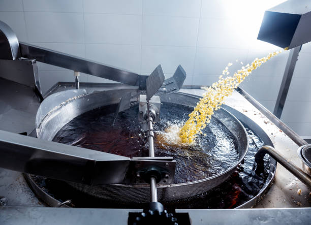 istock Conveyor line for frying snacks and chips in a modern factory 1299582133