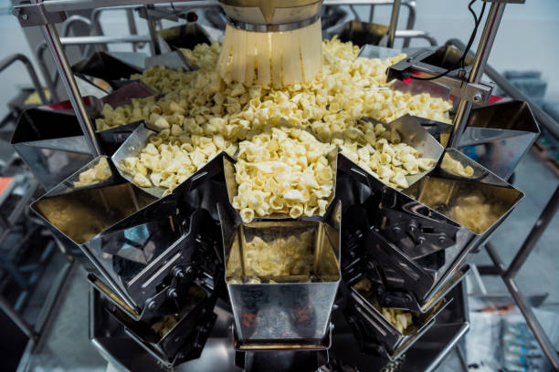 istock Vertical multi-head weigher packaging machine snacks and chips in a factory 1299583353