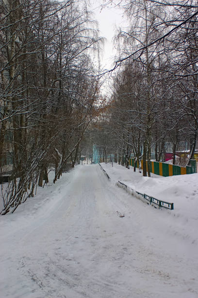 istock snow road inside a residential block 1299585186