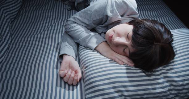 istock Mature woman is sleeping in bed 1299585400