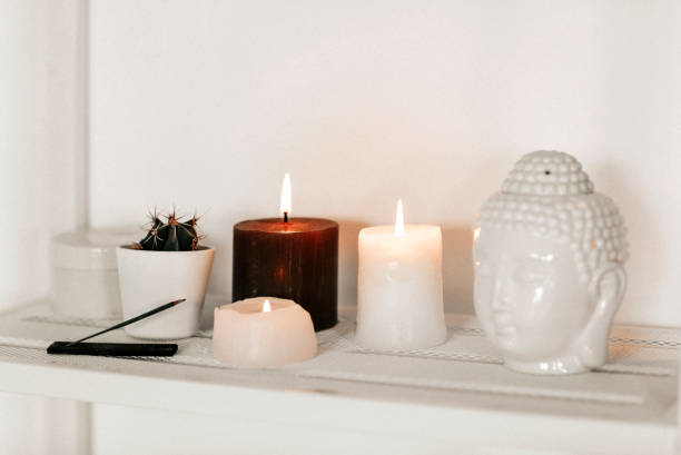 istock Candles and incense near Buddha head and cactus 1299585557