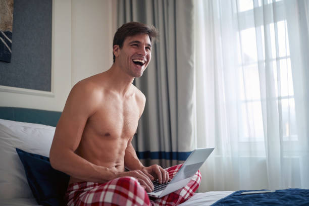 istock Topless man chatting on laptop; Distance relationship concept 1299585636
