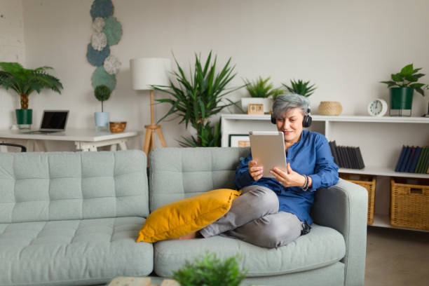 Mature woman works from home stock photo