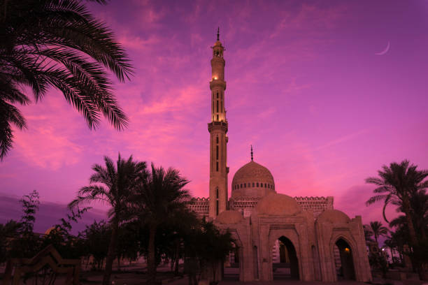 istock Beautiful large Islamic mosque at the sunset sky background 1299588627