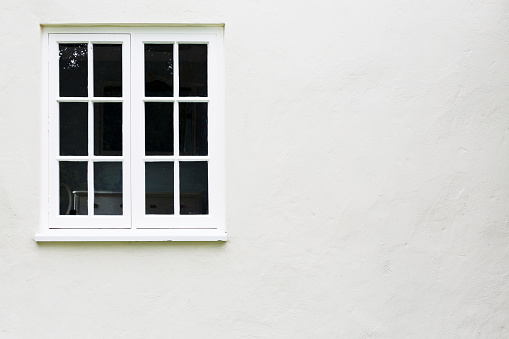 Window background. White timber or wooden windows on a house in UK.